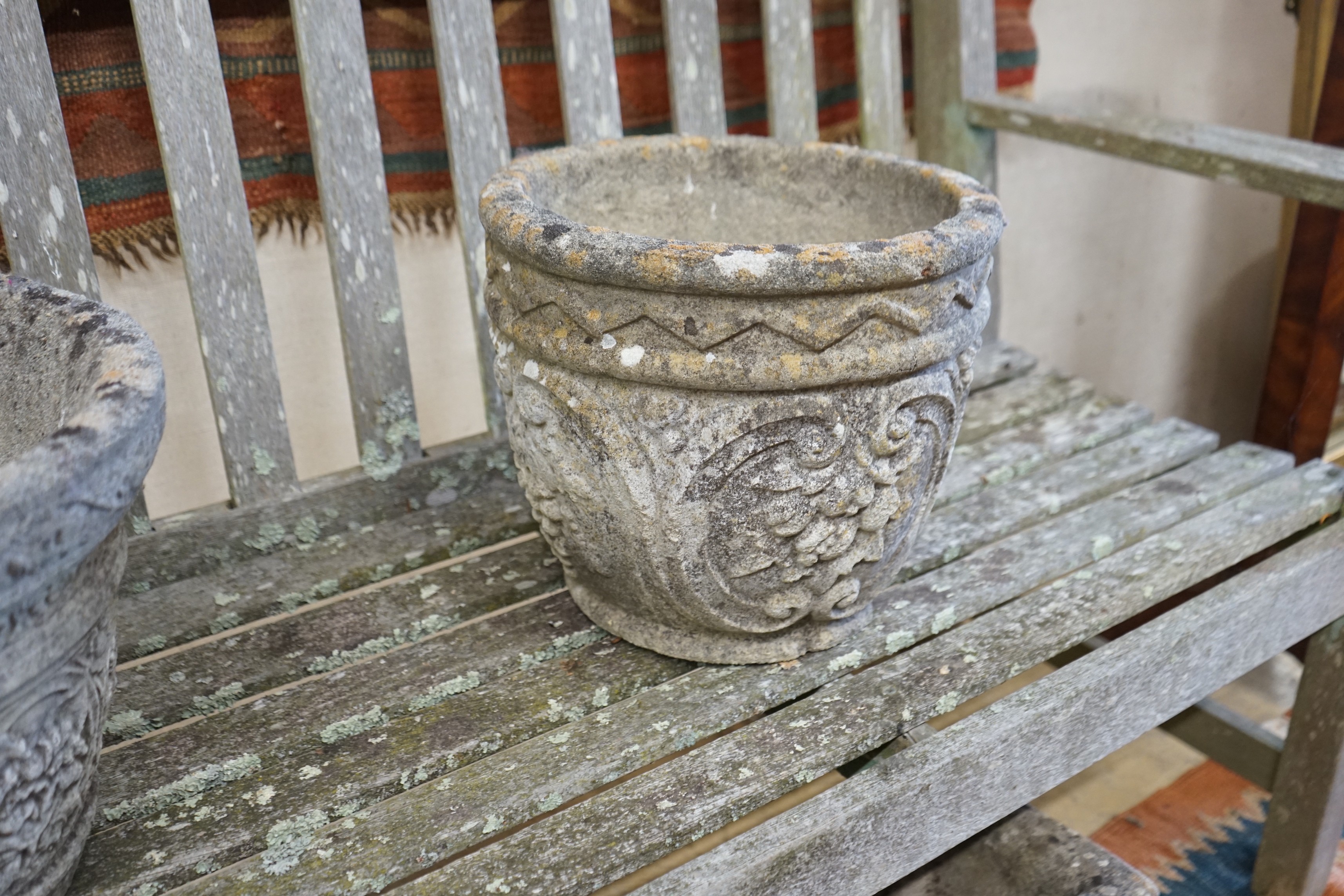 Three circular reconstituted stone garden planters, largest diameter 40cm, height 32cm